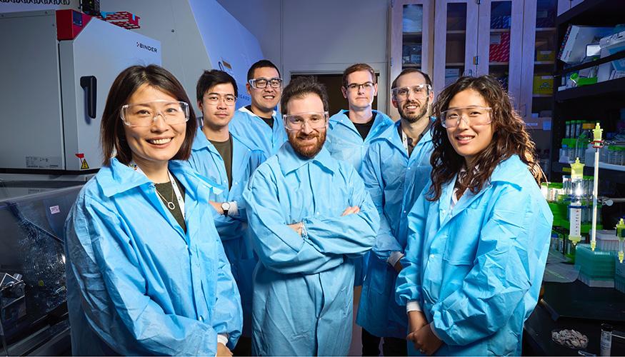 image of people wearing blue lab coats standing together